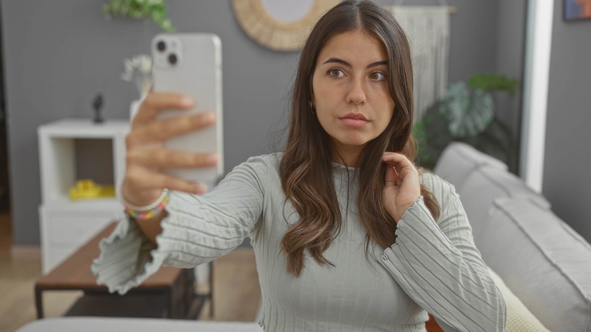 self-centered woman taking selfies before leaving the house