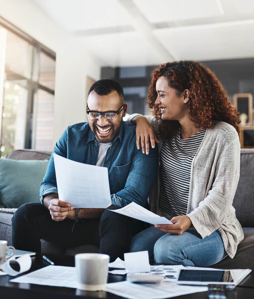 happy couple paying bills together