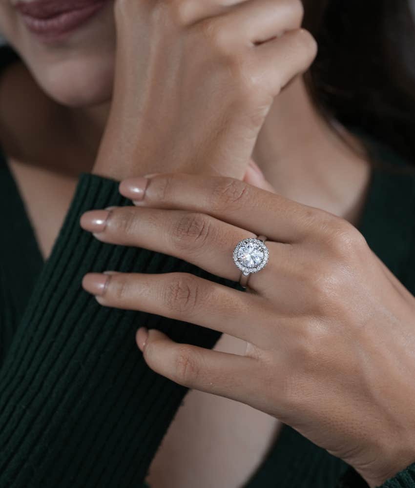 Woman wearing a ring on her middle finger even though she shouldn't if she wants a peaceful life