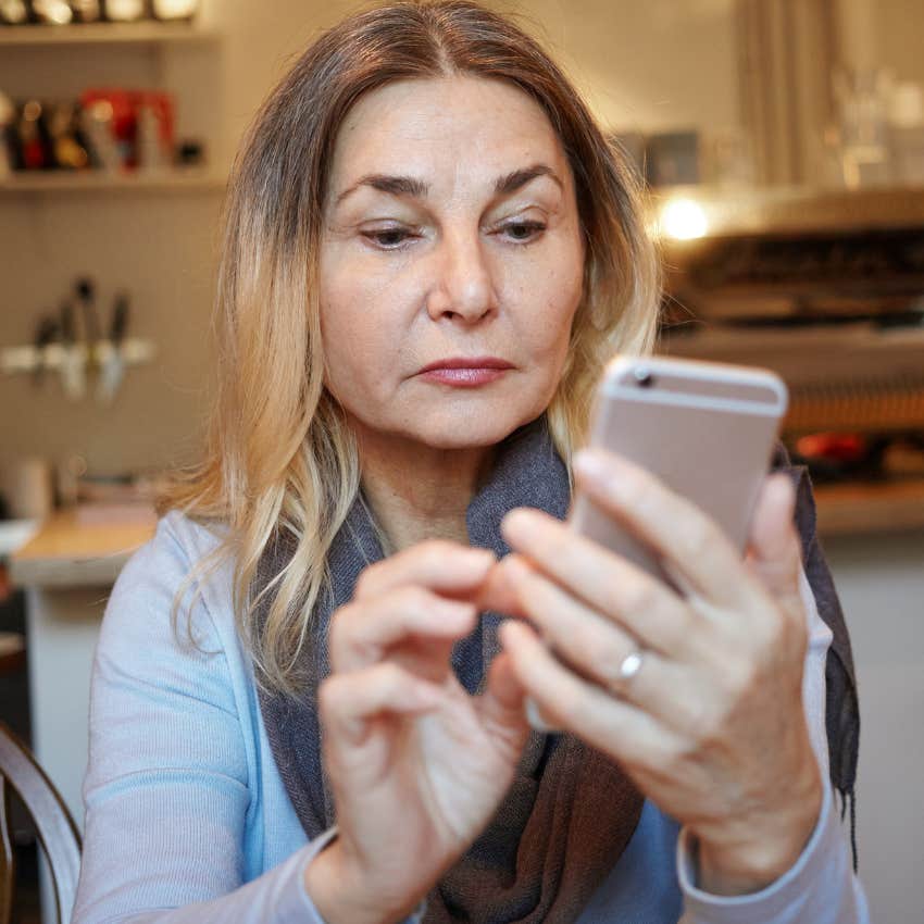 older woman texting her adult children to come over and visit