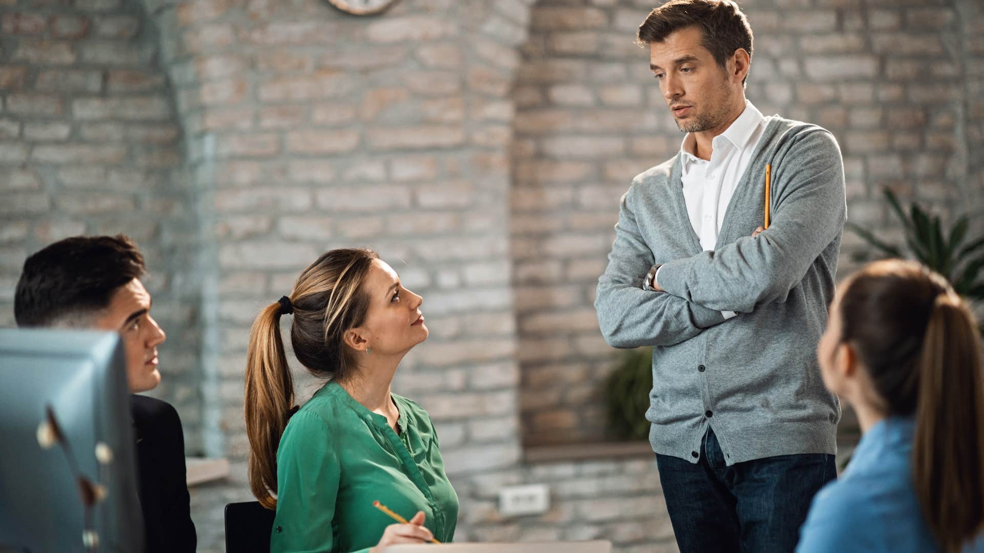 man who is covering vulnerable body parts as a sign of deception