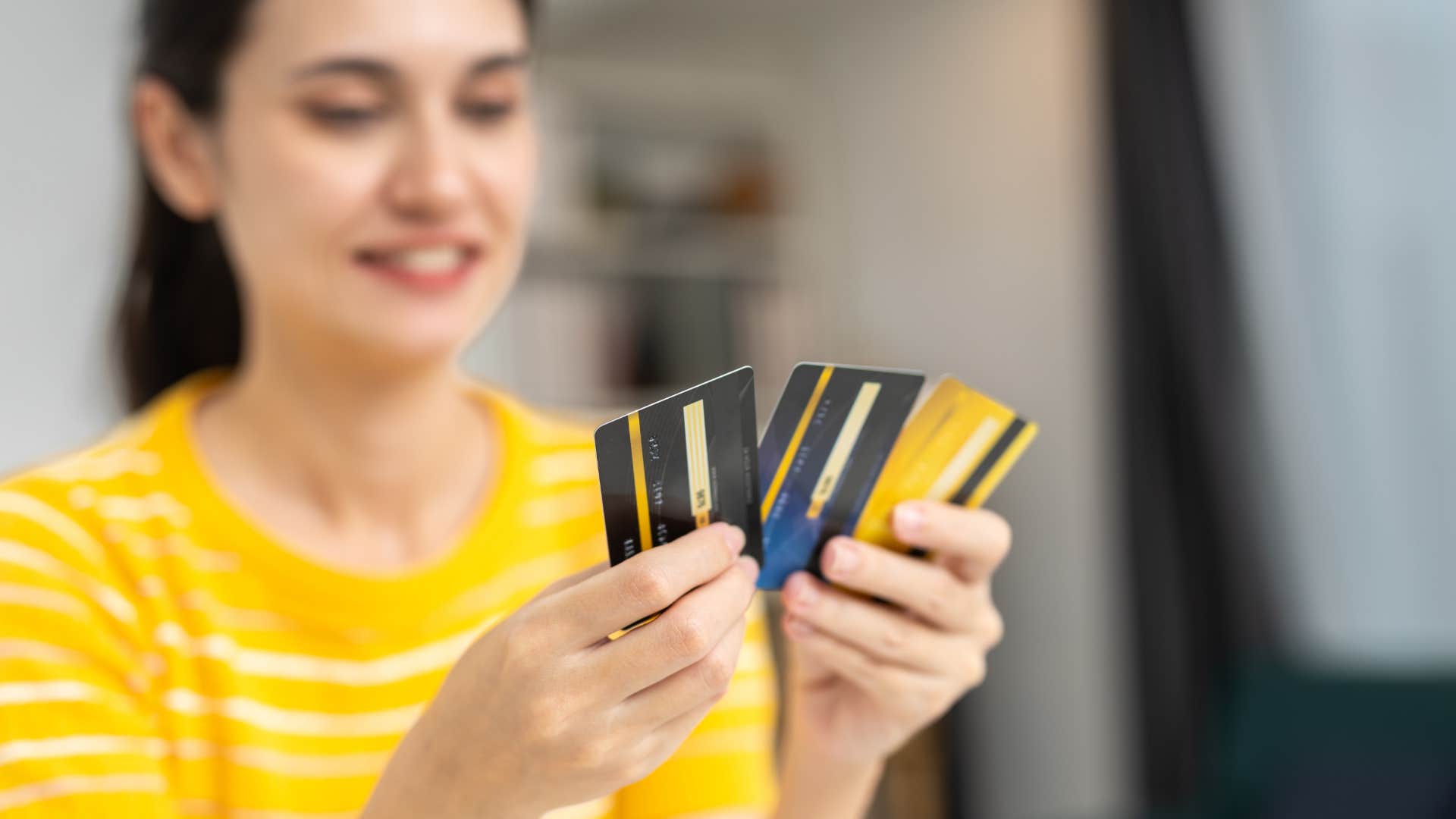 woman with money trouble as she has a stack of credit cards