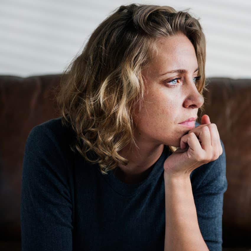 Woman avoiding discomfort at home.