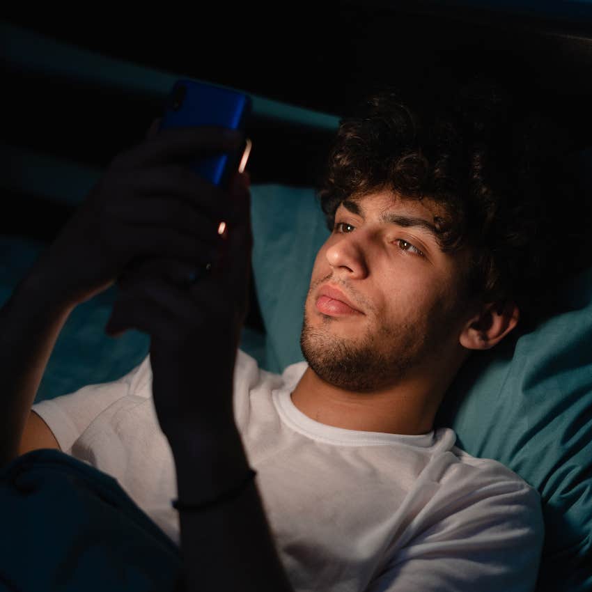 Man who's never picking up a book looking at his phone.