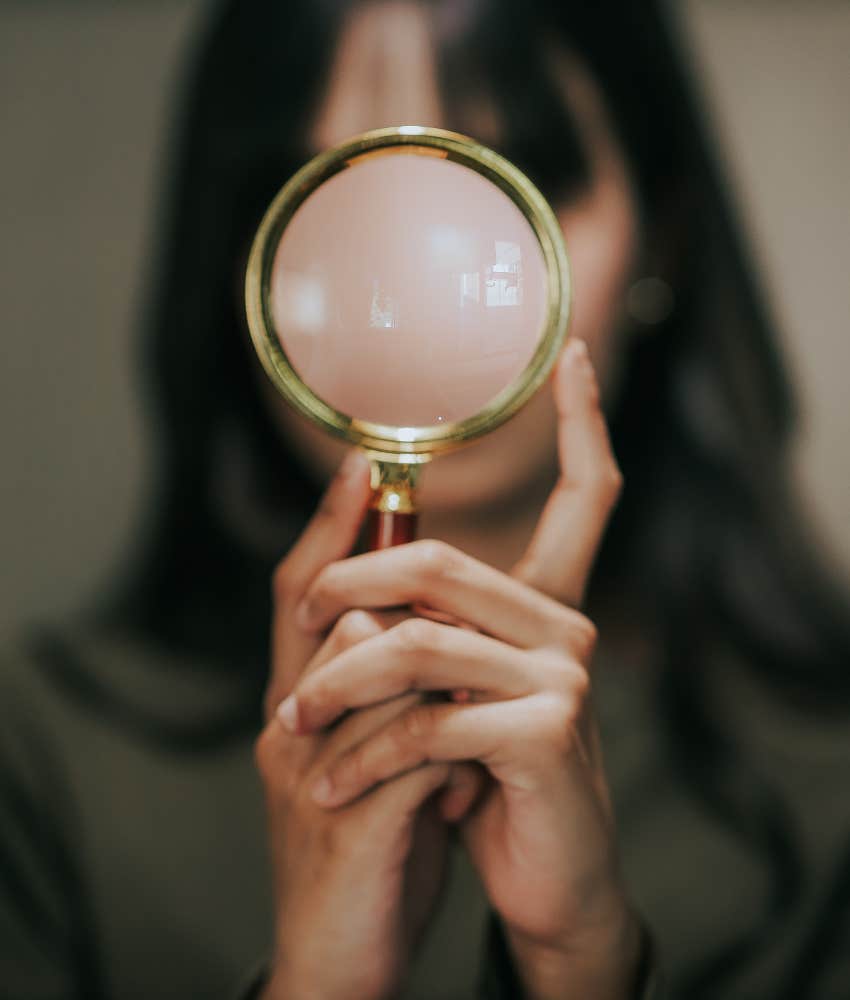 Analytic person with magnifying glass showing overthinking to find hidden meaning