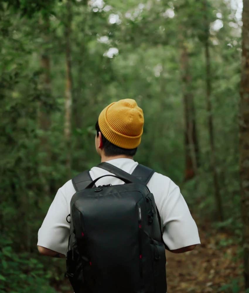 Man staying calm when everything goes wrong by taking a walk in the woods
