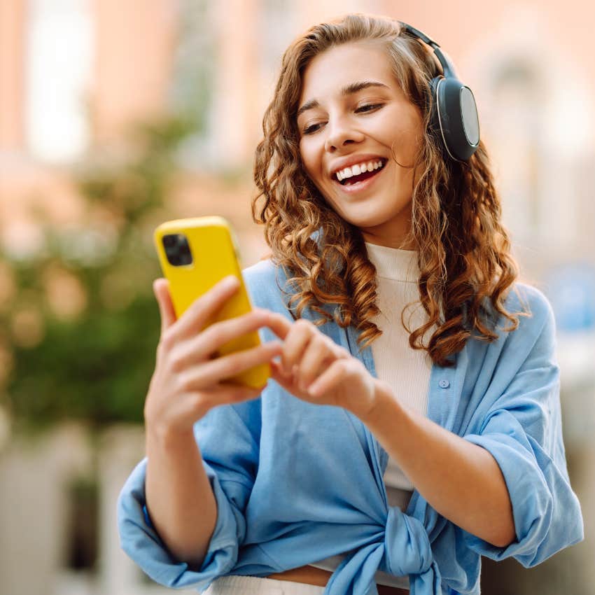woman who lives a happier life by listening to upbeat music