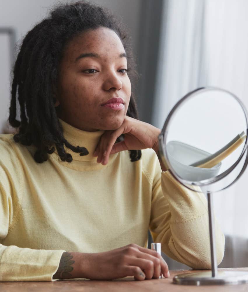 Serious person looks in mirror showing study of self to argue better