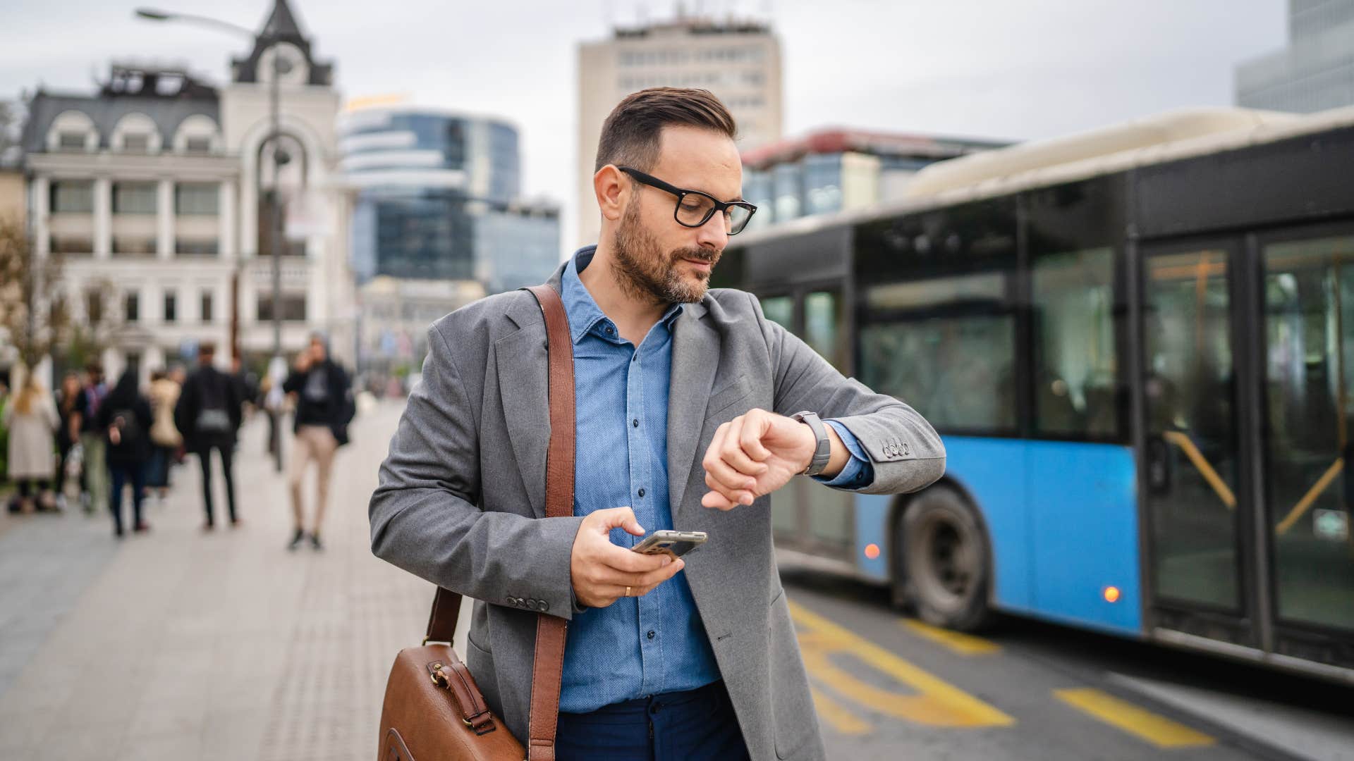 man in gray jacket looking at watch as he says i've waited long enough
