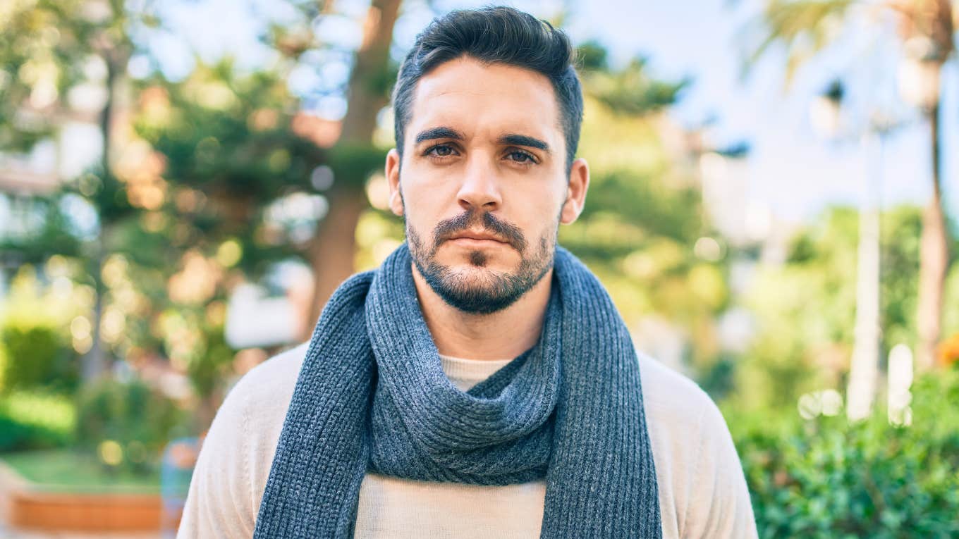 serious young man standing outside