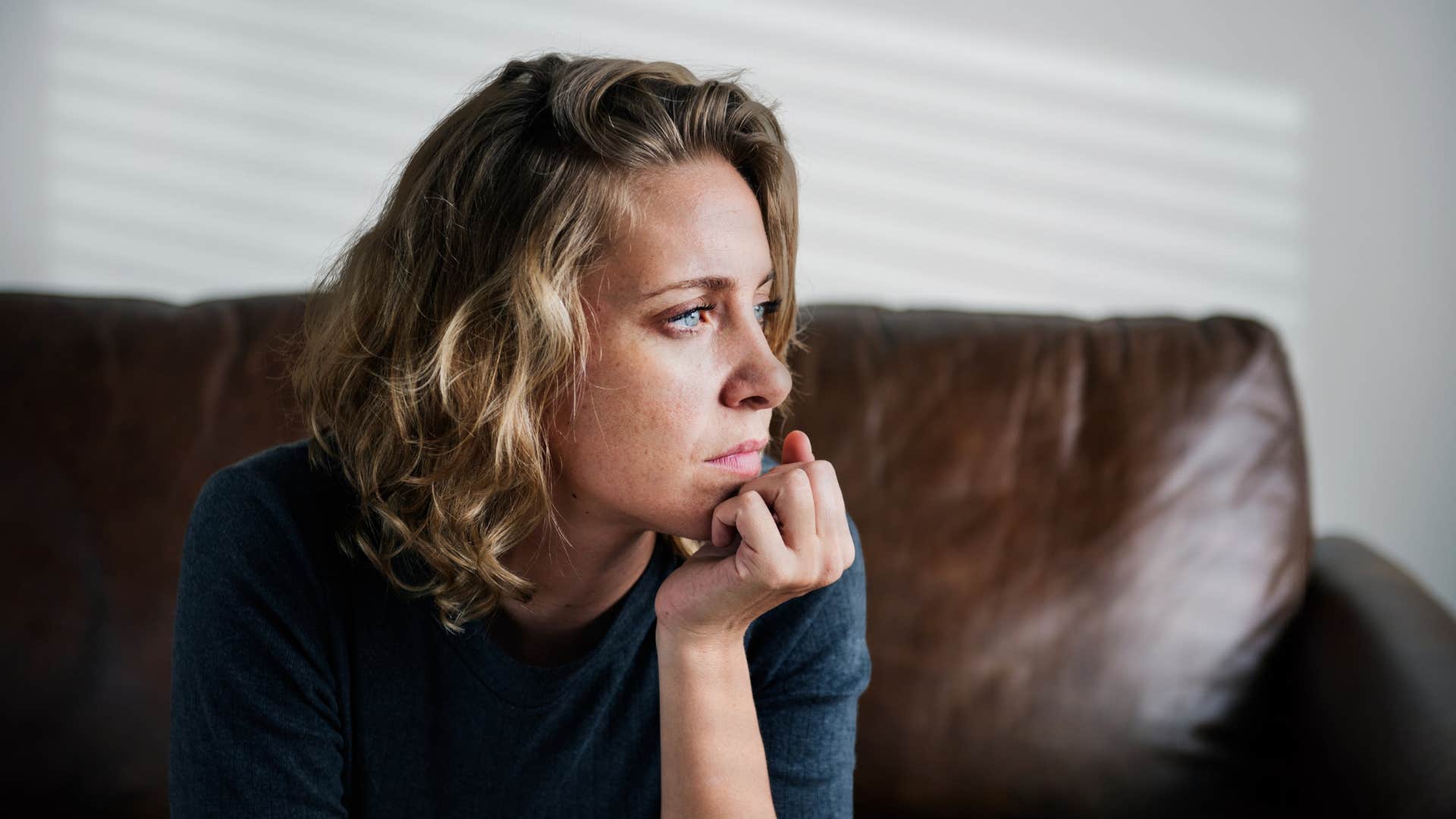 sad woman at home unsure how to explain how she feels