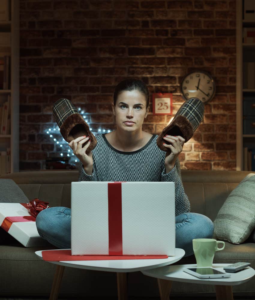 woman opening bad christmas gift