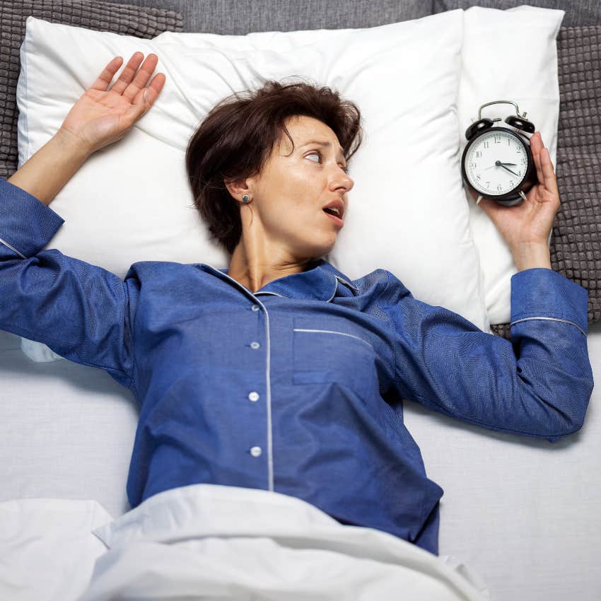 Woman questioning the spiritual meaning for constantly waking up in the middle of the night