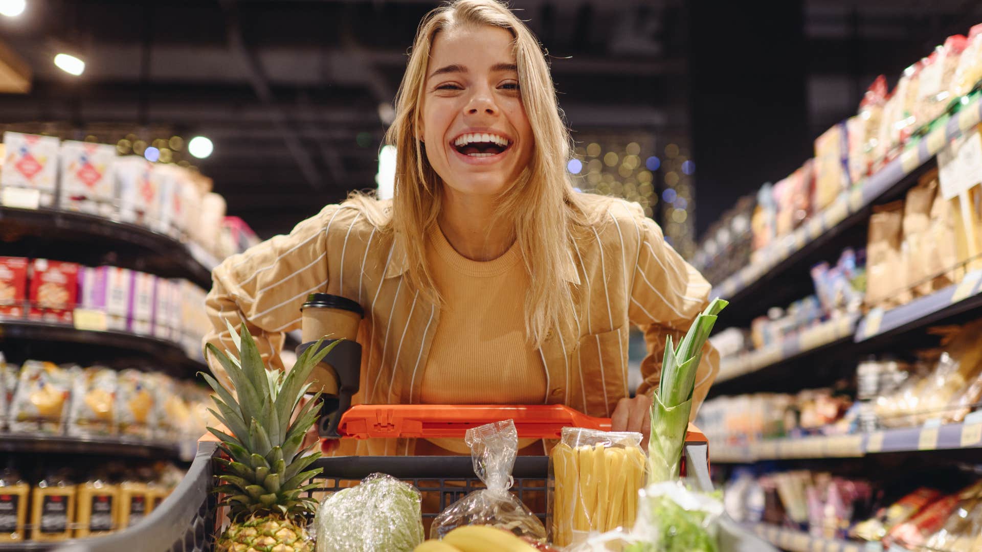 happy woman shopping for brand-name foods at grocery store