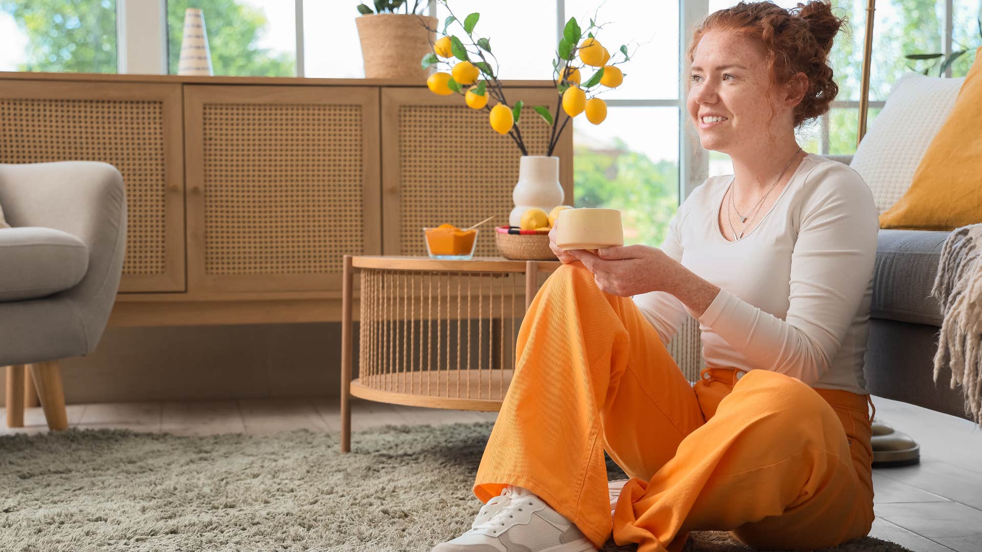 upper middle class woman sitting in her carpeted home