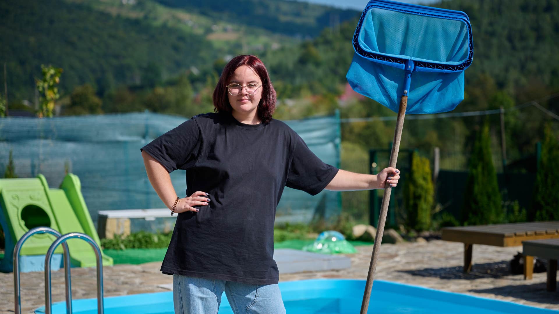 woman standing in front of her in-ground pool