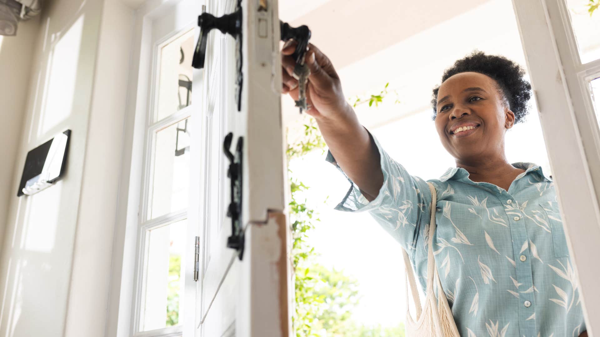 woman opening front door at home