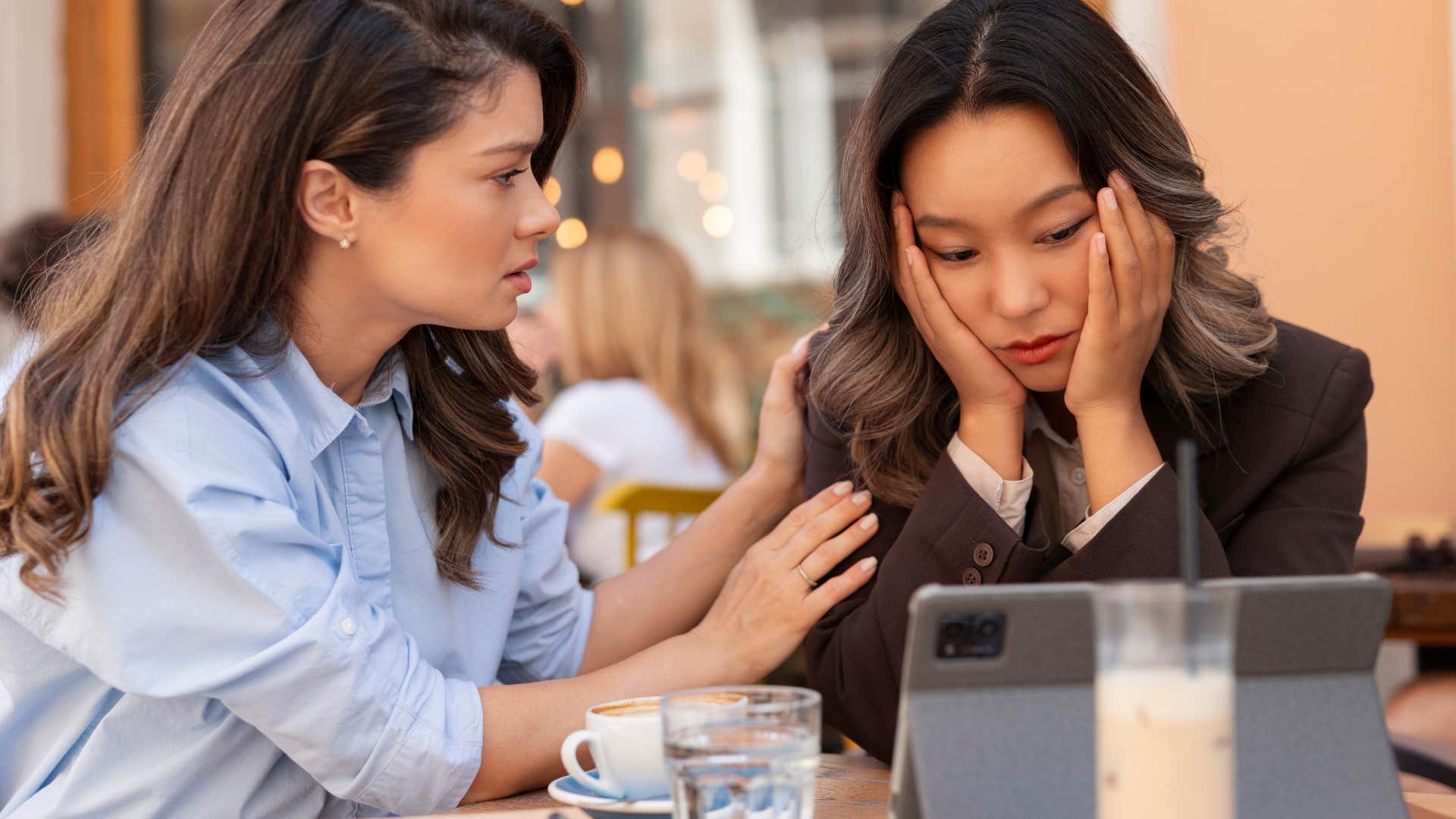 woman comforting friend lifting her up