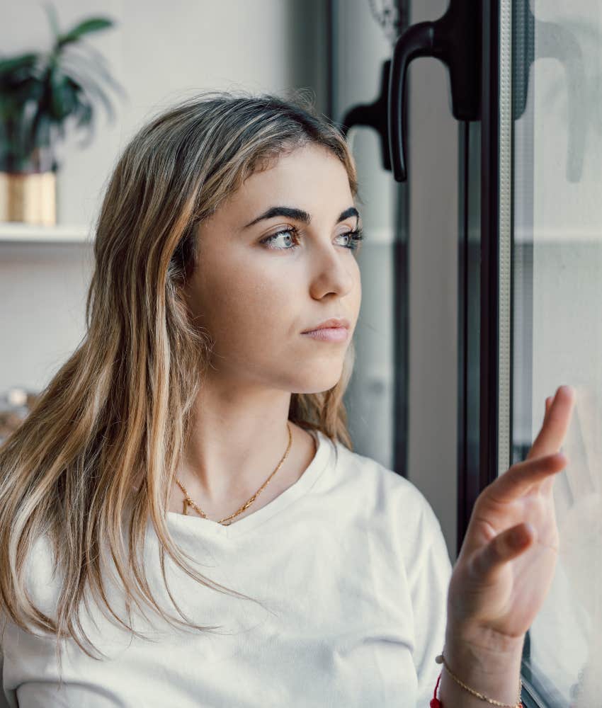 millennial woman unable to relax looking out window