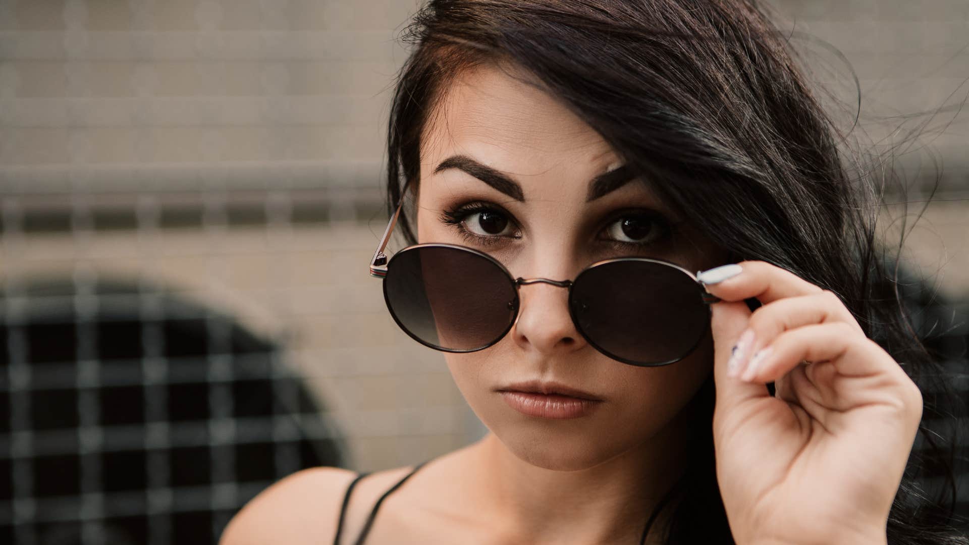 wealthy woman flaunting wealth with sunglasses