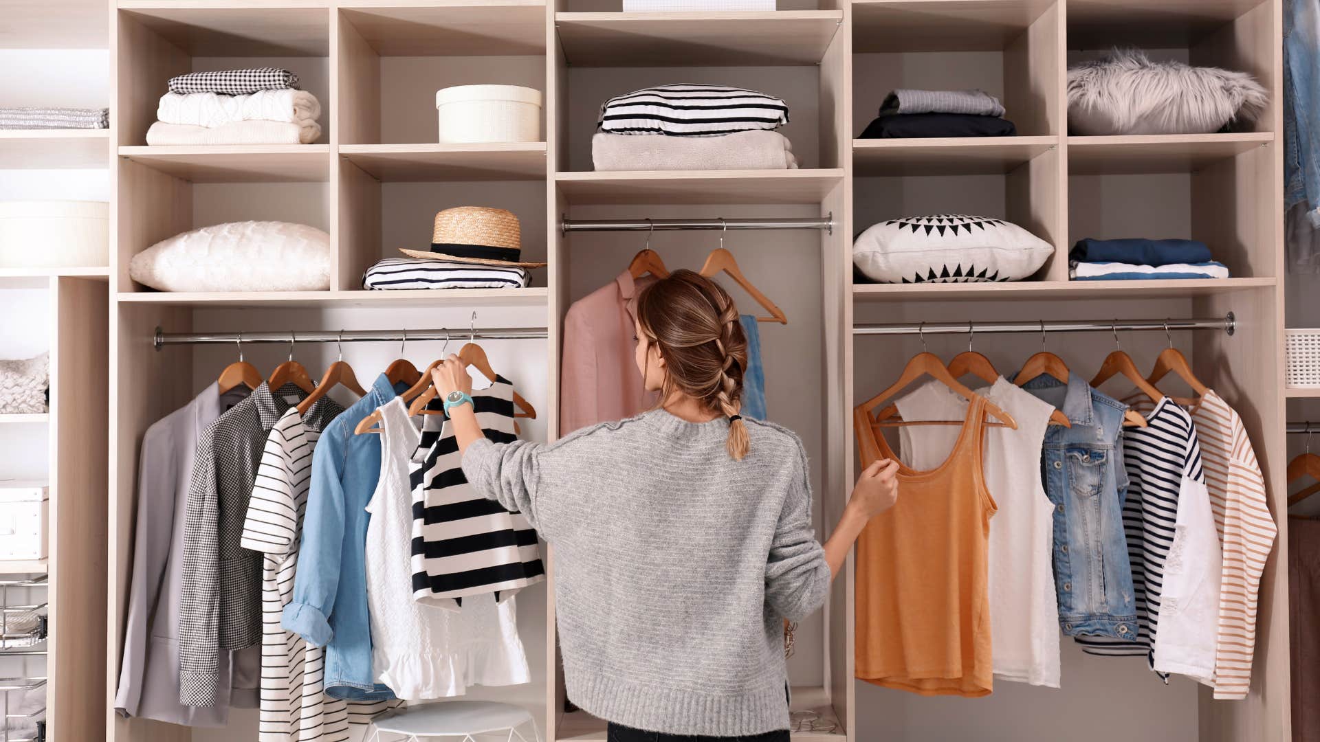 wealthy woman in her materialistic closet at home