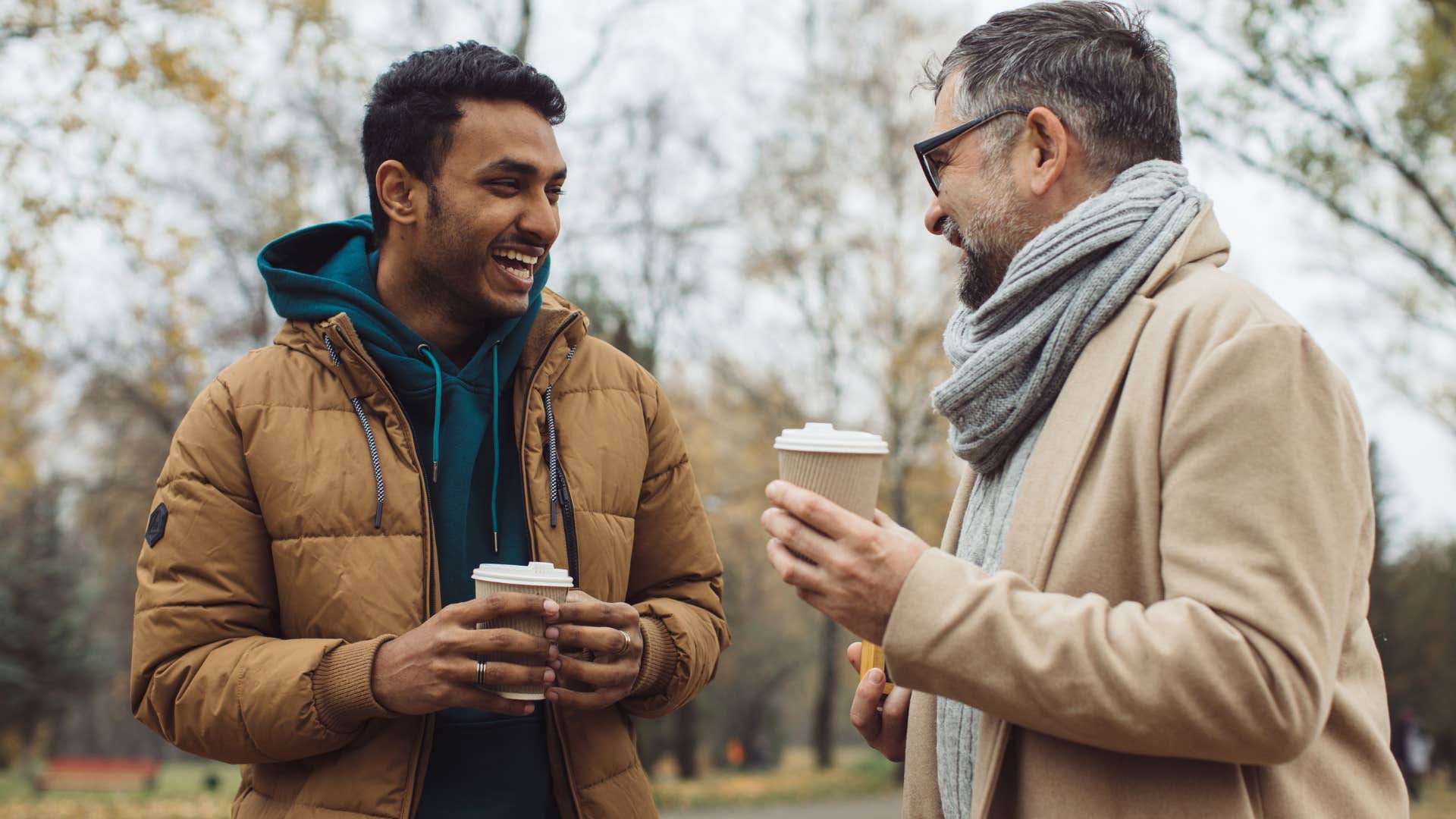 man smiling telling friend that's a great point over coffee