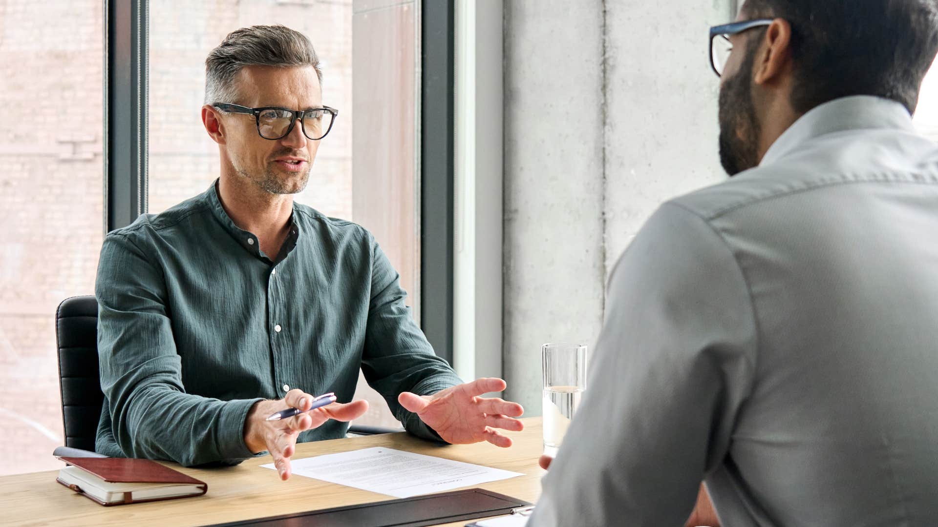 man saying I understand where you're coming from to a colleague at work