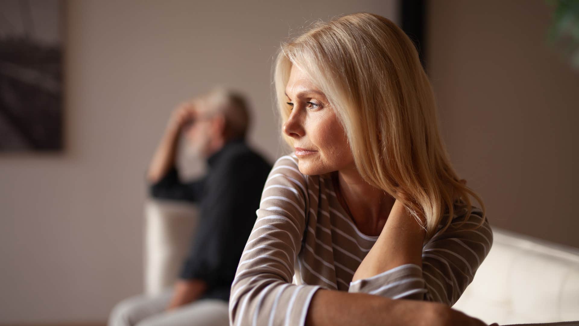 woman turning away from husband feeling disappointment