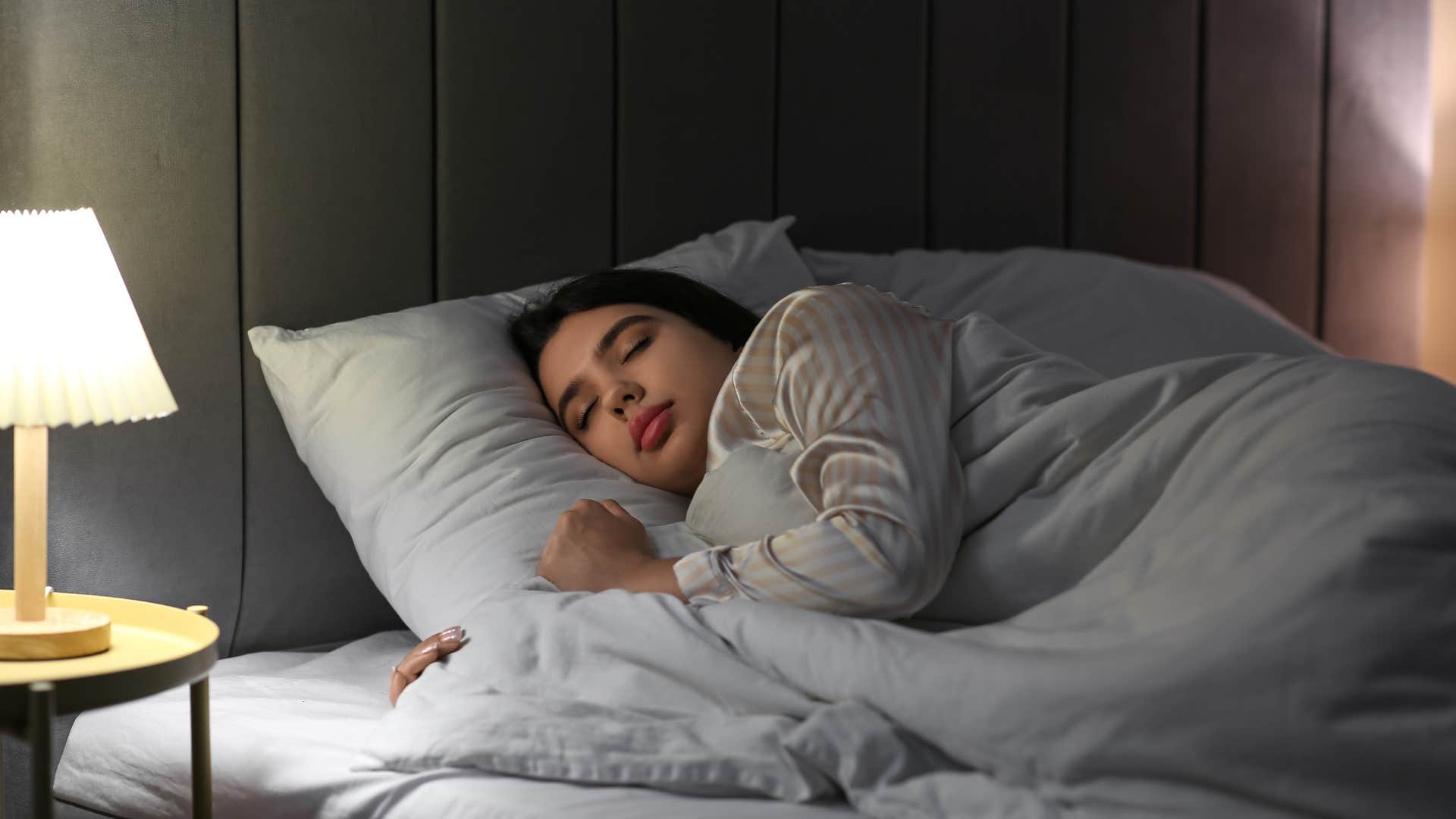 woman sleeping in bed with high quality sheets