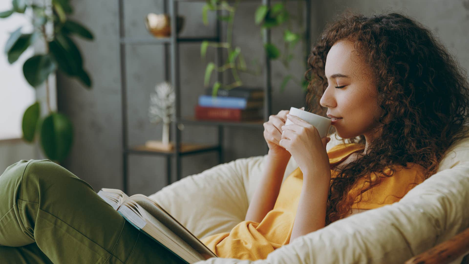 frugal woman sitting drinking cup of coffee at home