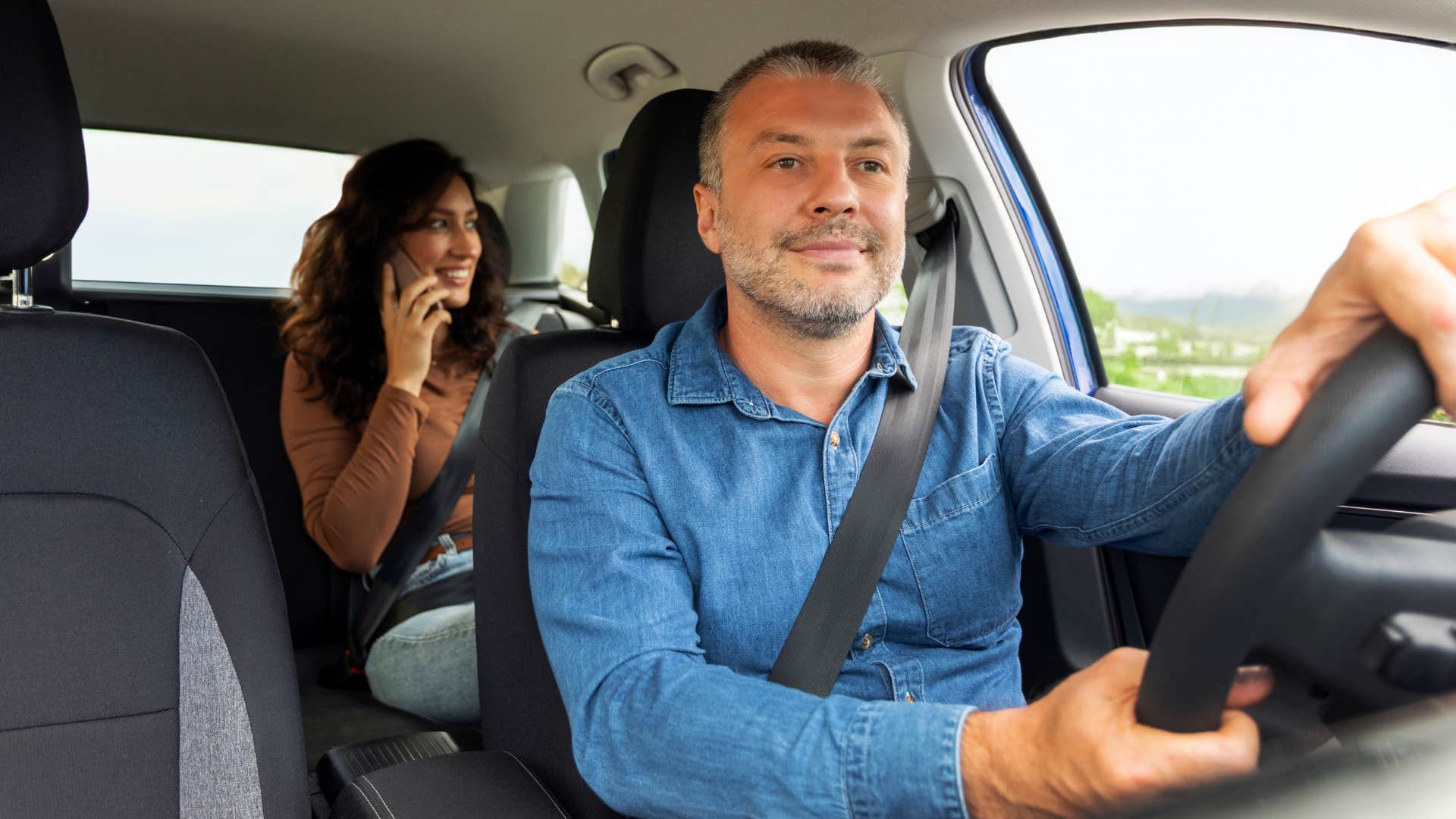 woman riding in backseat of uber