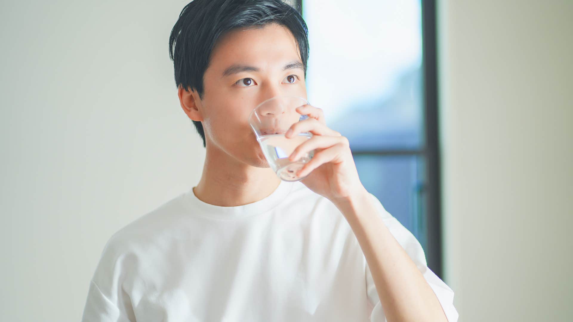 man drinking glass of water