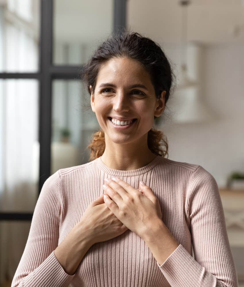 Sincere person hold hands to heart showing happy people forgive