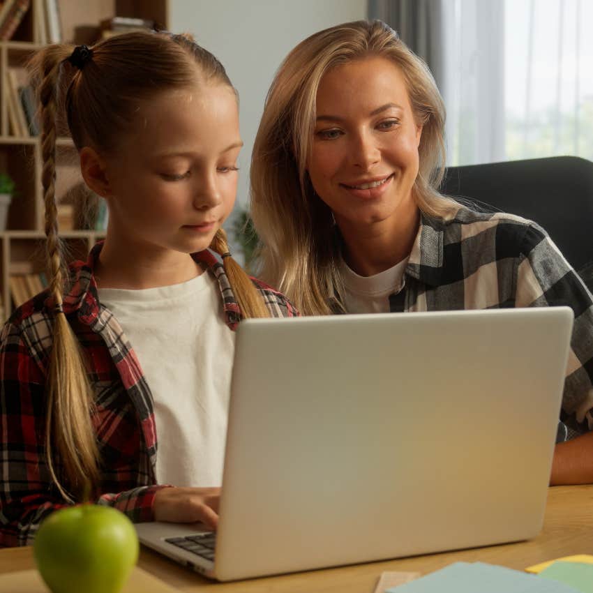 mom helping daughter with homework