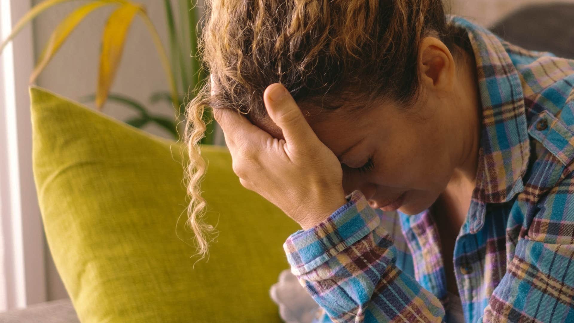 anxious woman with her head in her hands