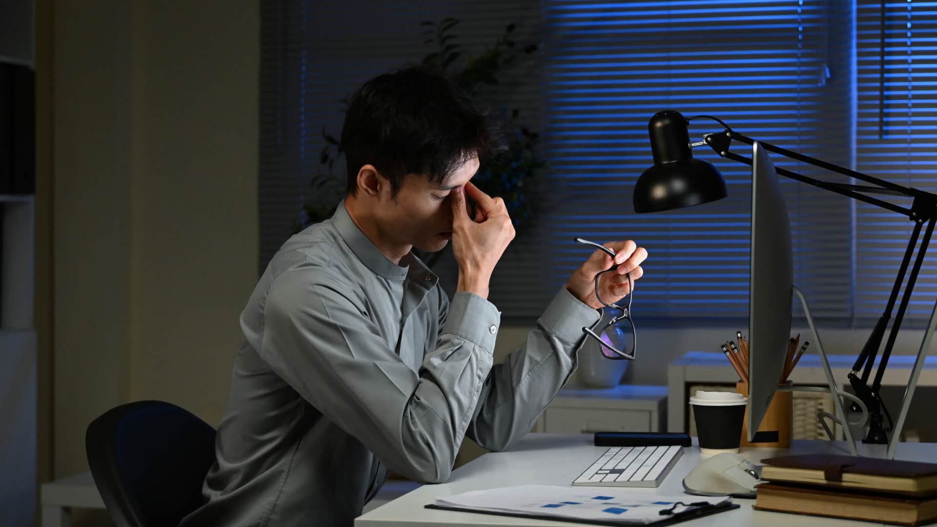 man not balancing self care as a parent as he looks stressed at work
