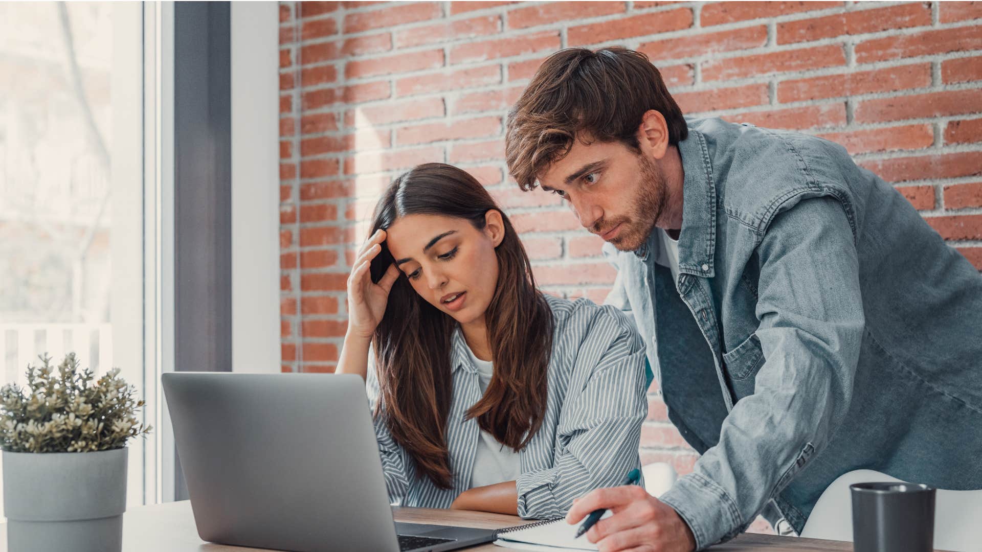 couple looking at bills as they discuss expensive childcare costs