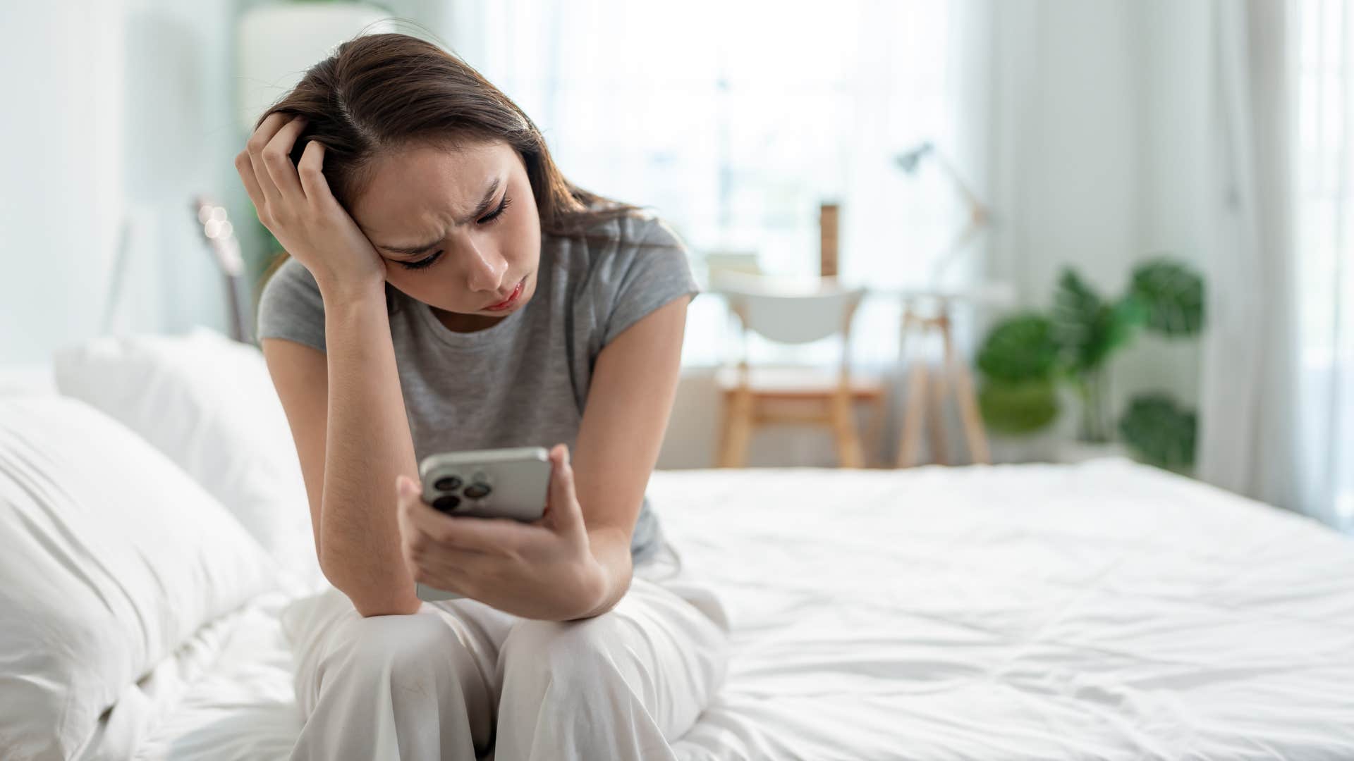 woman managing multiple school apps as she looks stressed