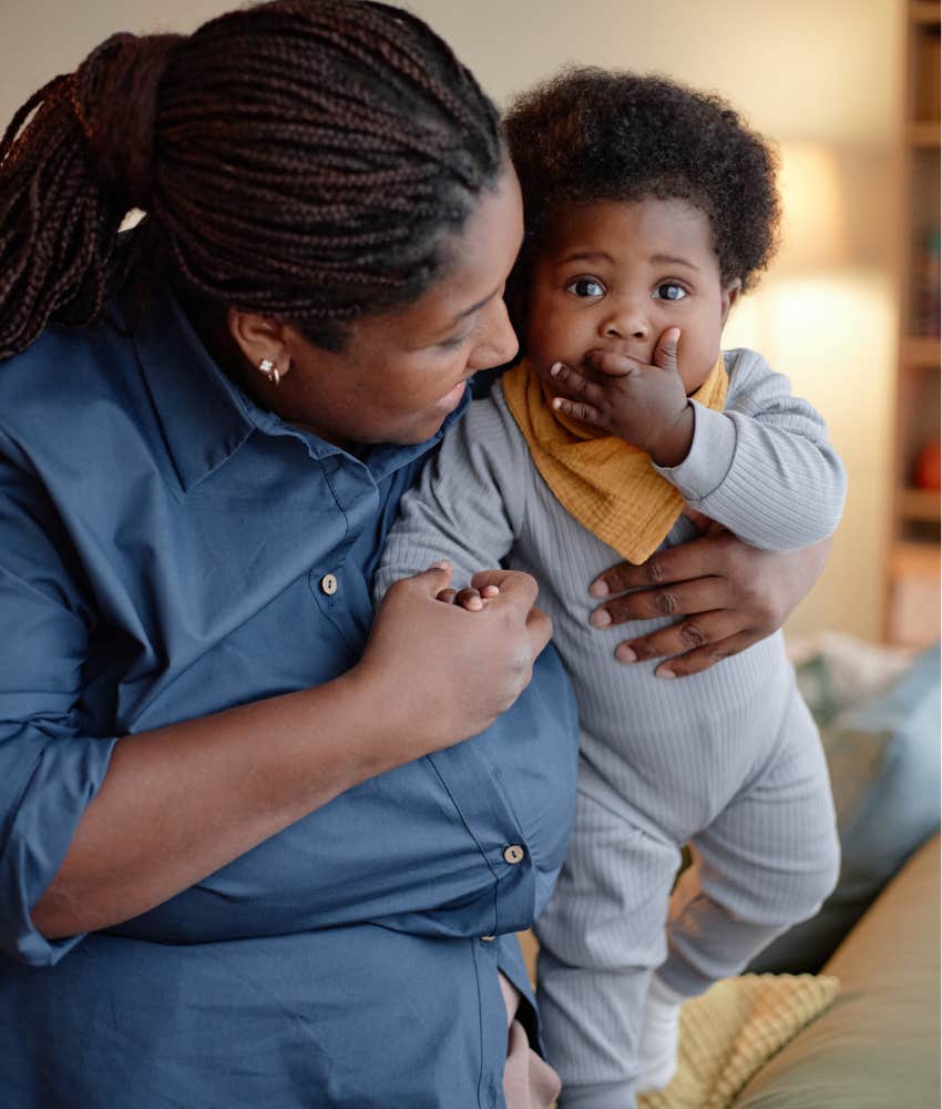 Happy woman with baby showing moms share love