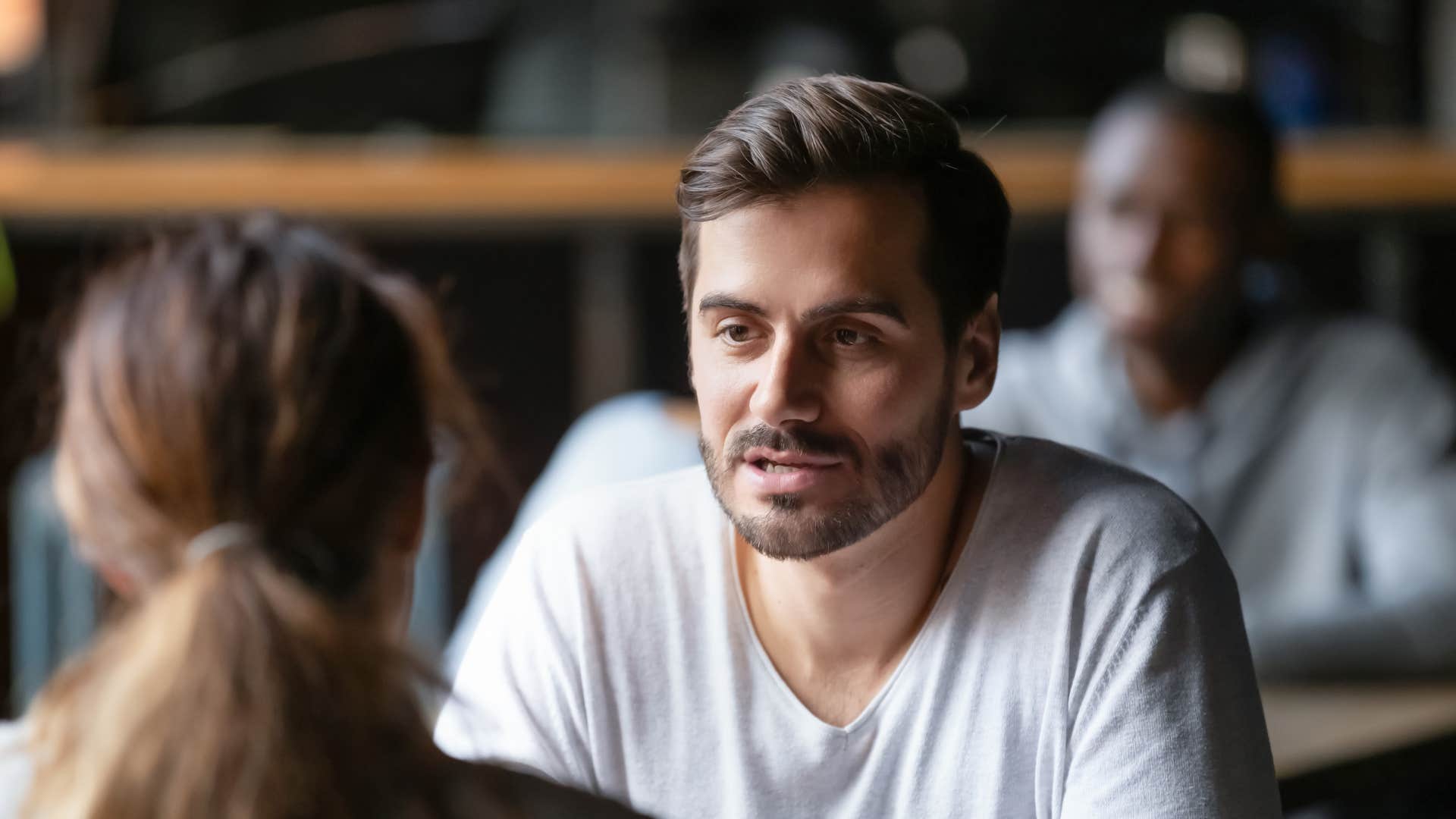 man talking to woman at lunch