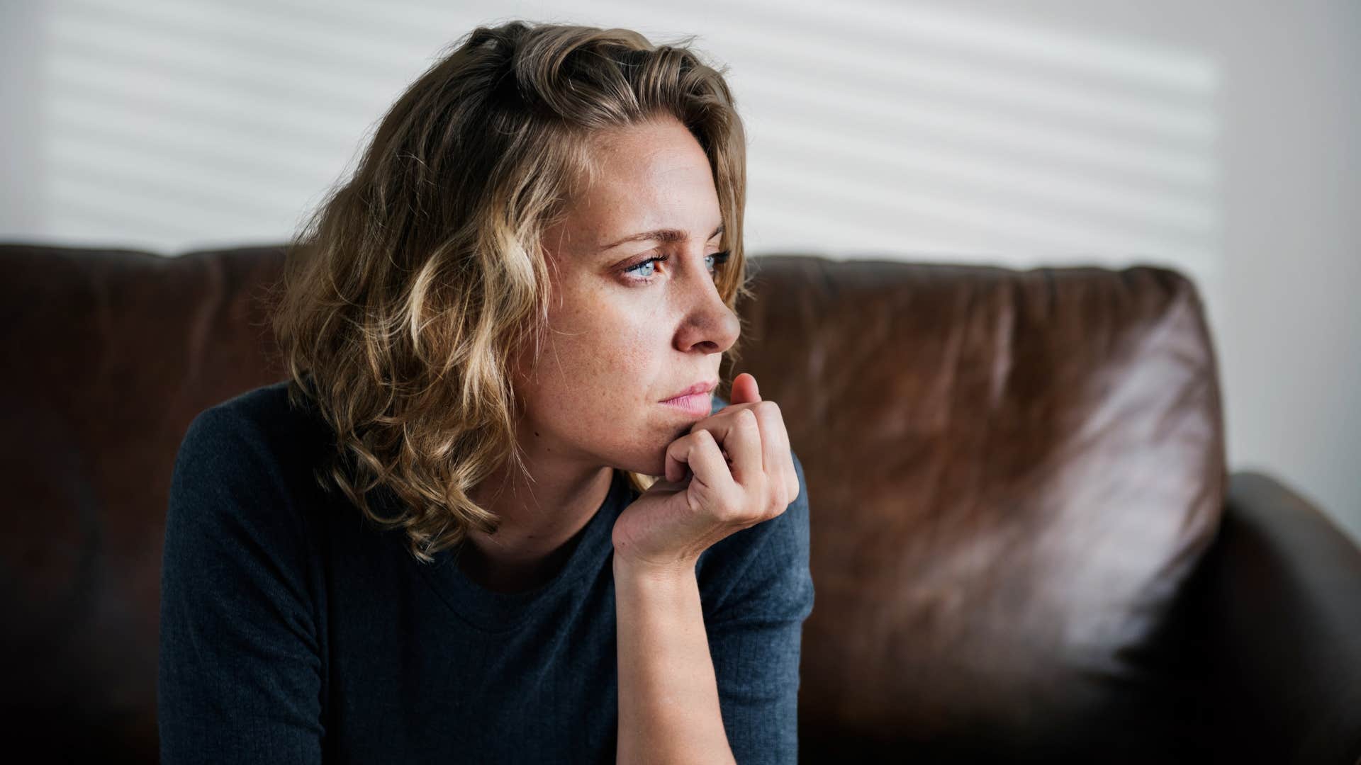 pensive woman replaying argument in her head