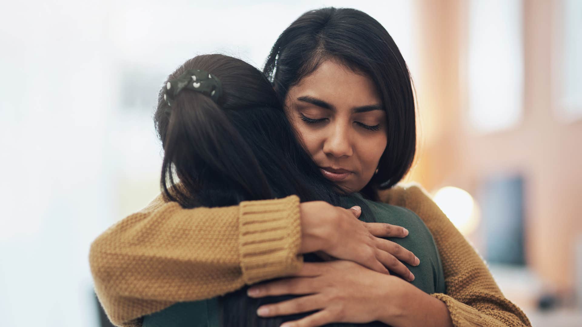 friends hugging and apologizing to each other