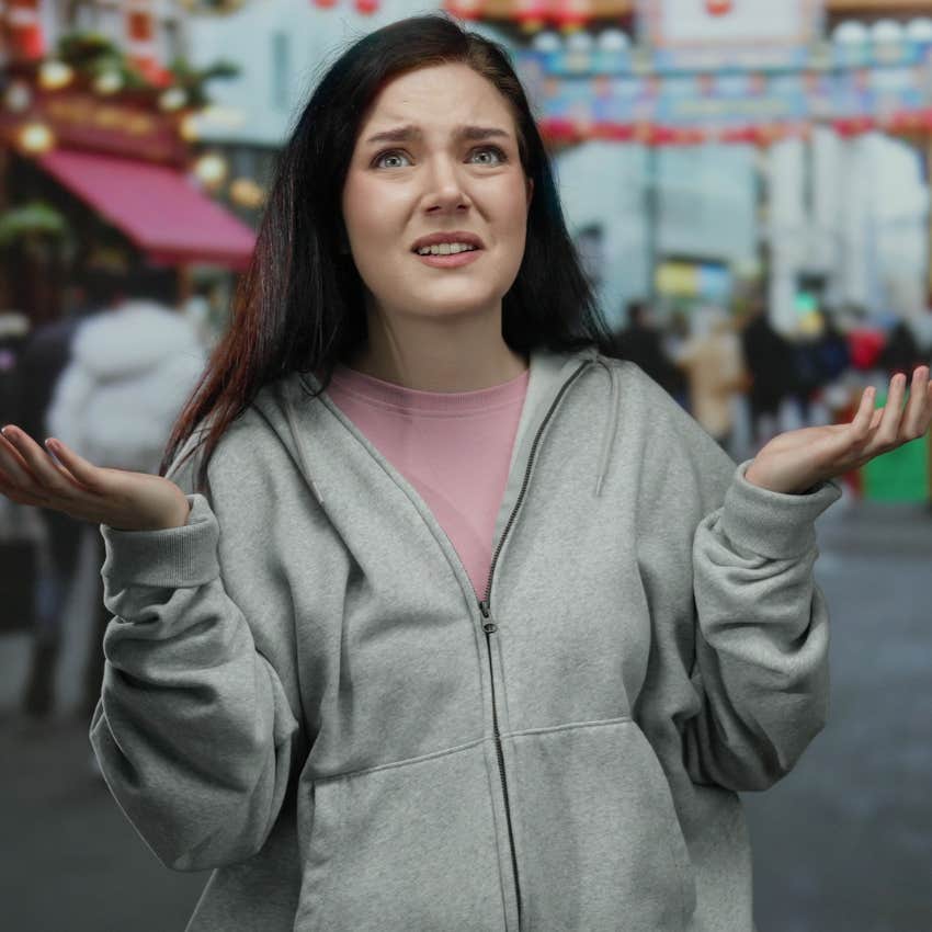 confused woman standing in a crowded space lacking common sense