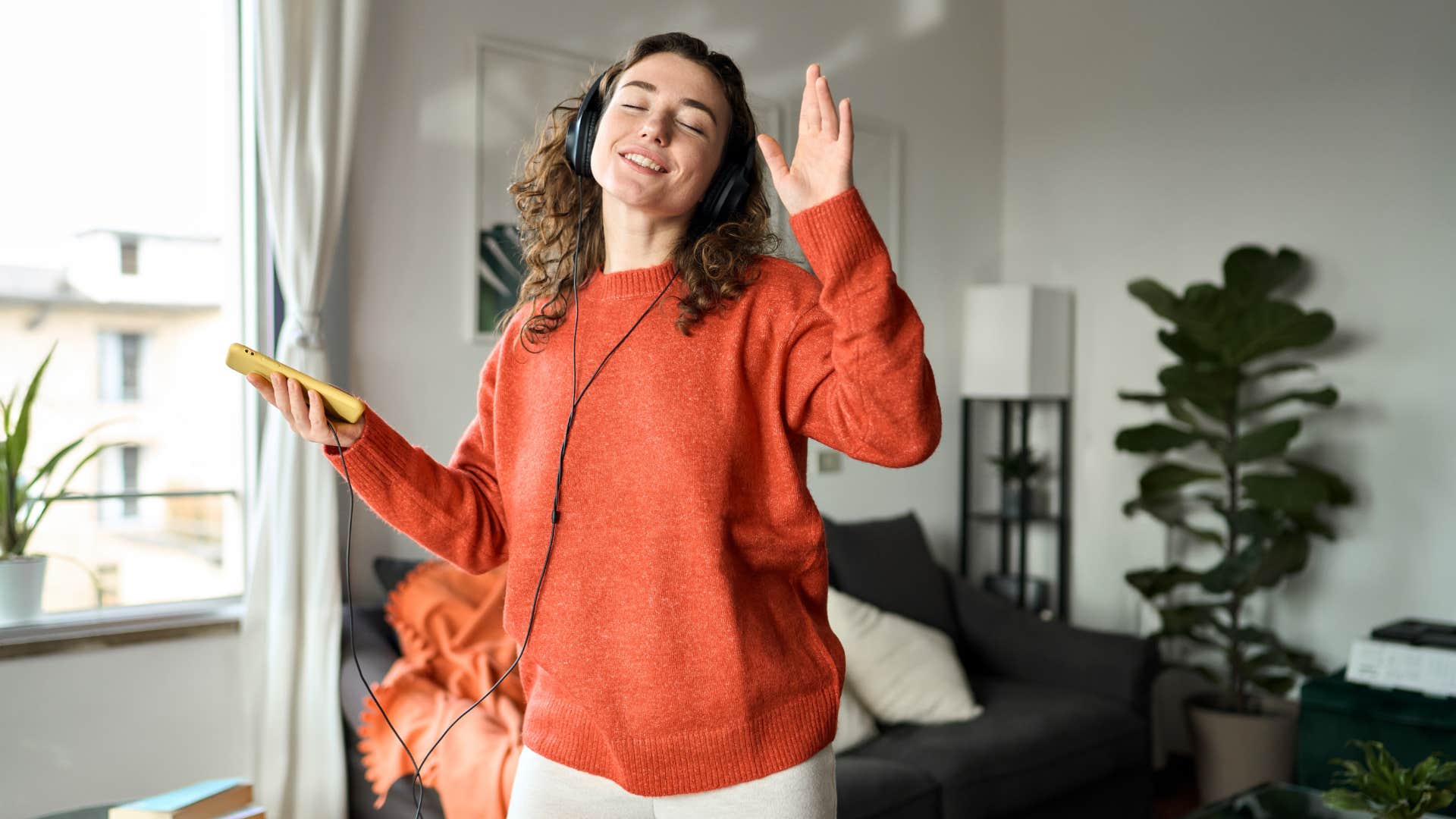 woman creating a pump me up playlist before a first date