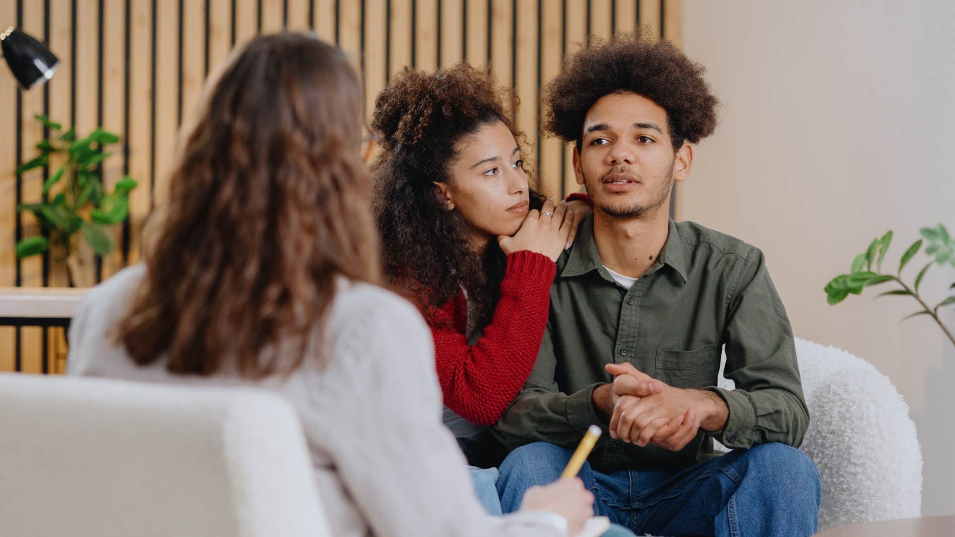 doctor addressing husband over woman
