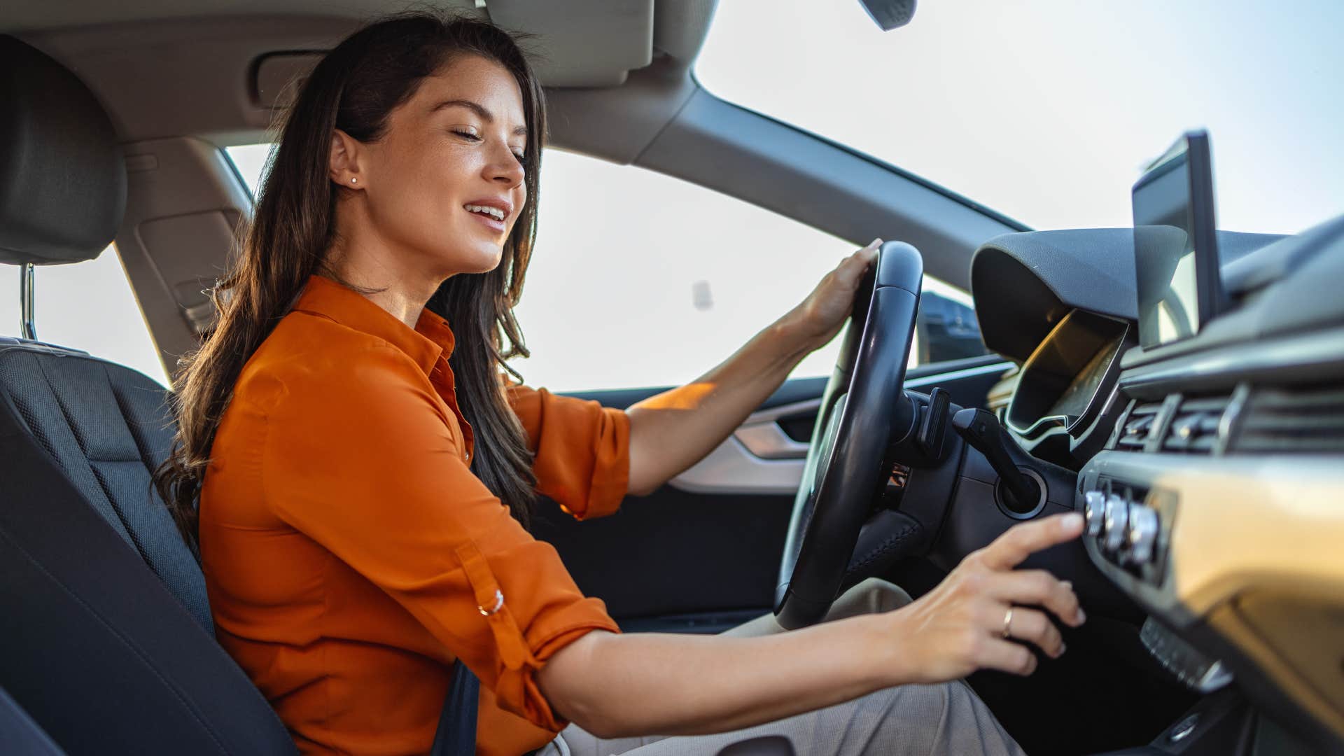 woman driving tuning the radio
