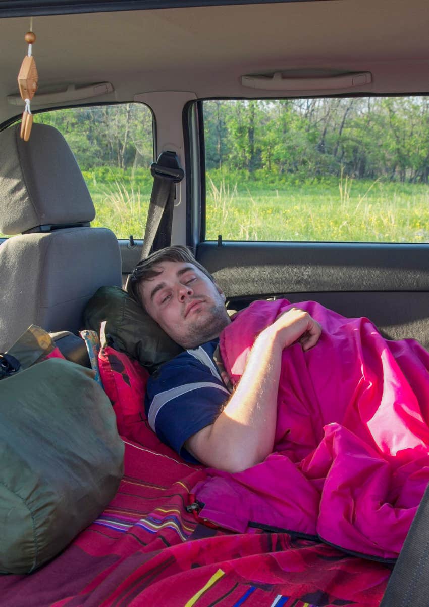 college student sleeping in his car