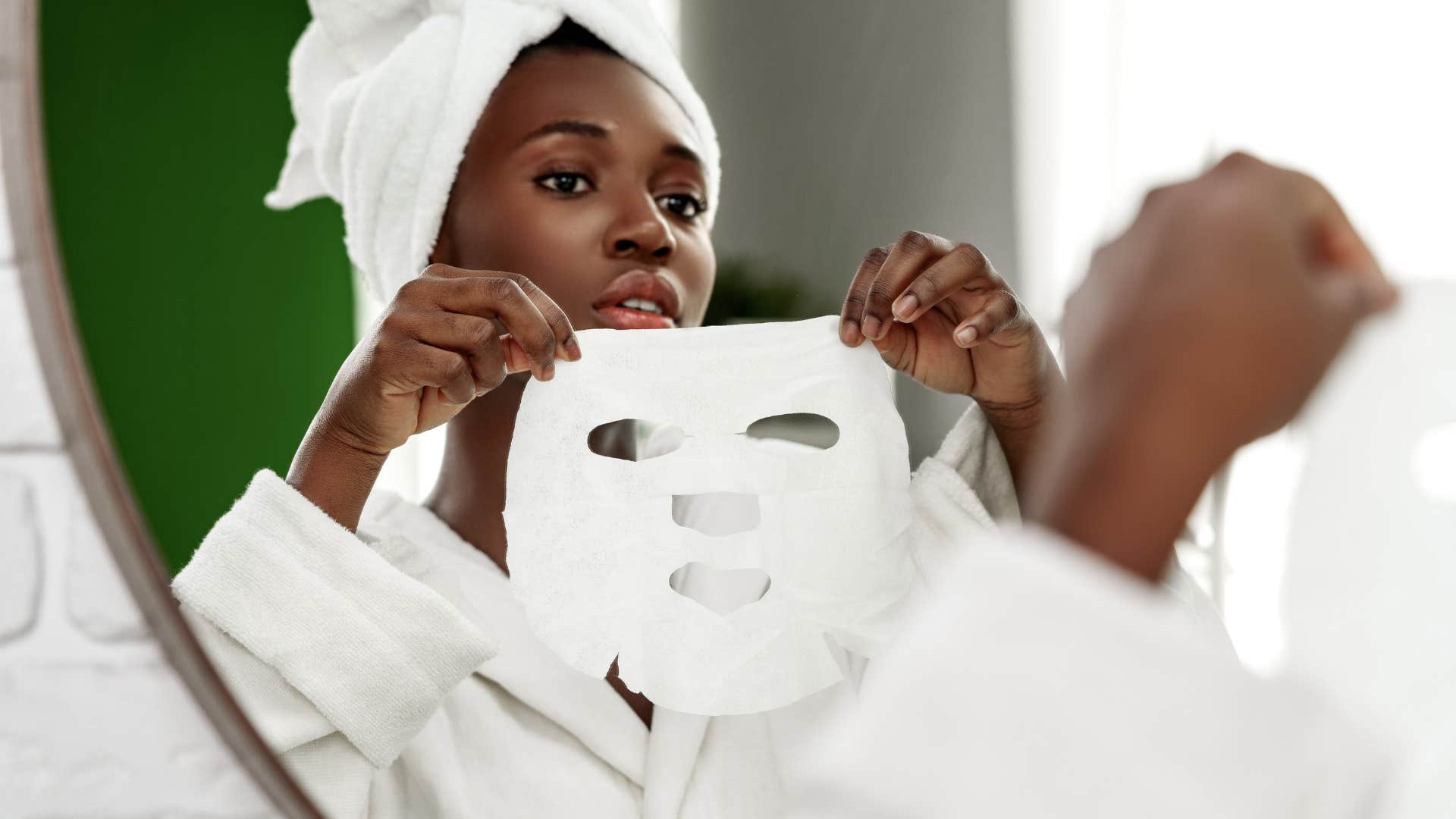 woman keeping a weekly self-care routine putting on face mask
