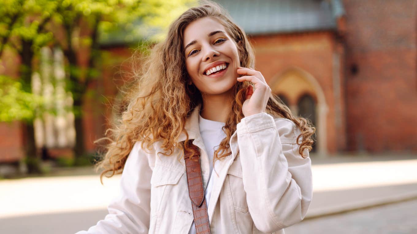 young woman touching her hair outside