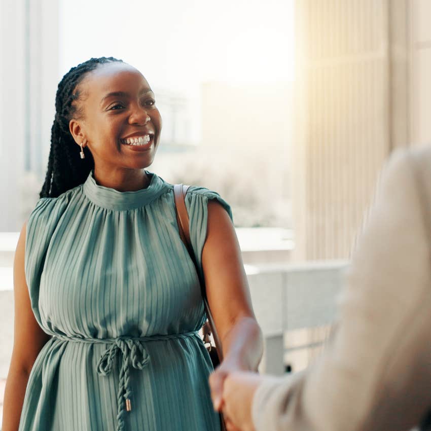 people-pleasing woman shaking hands saying yes when she wants to say no